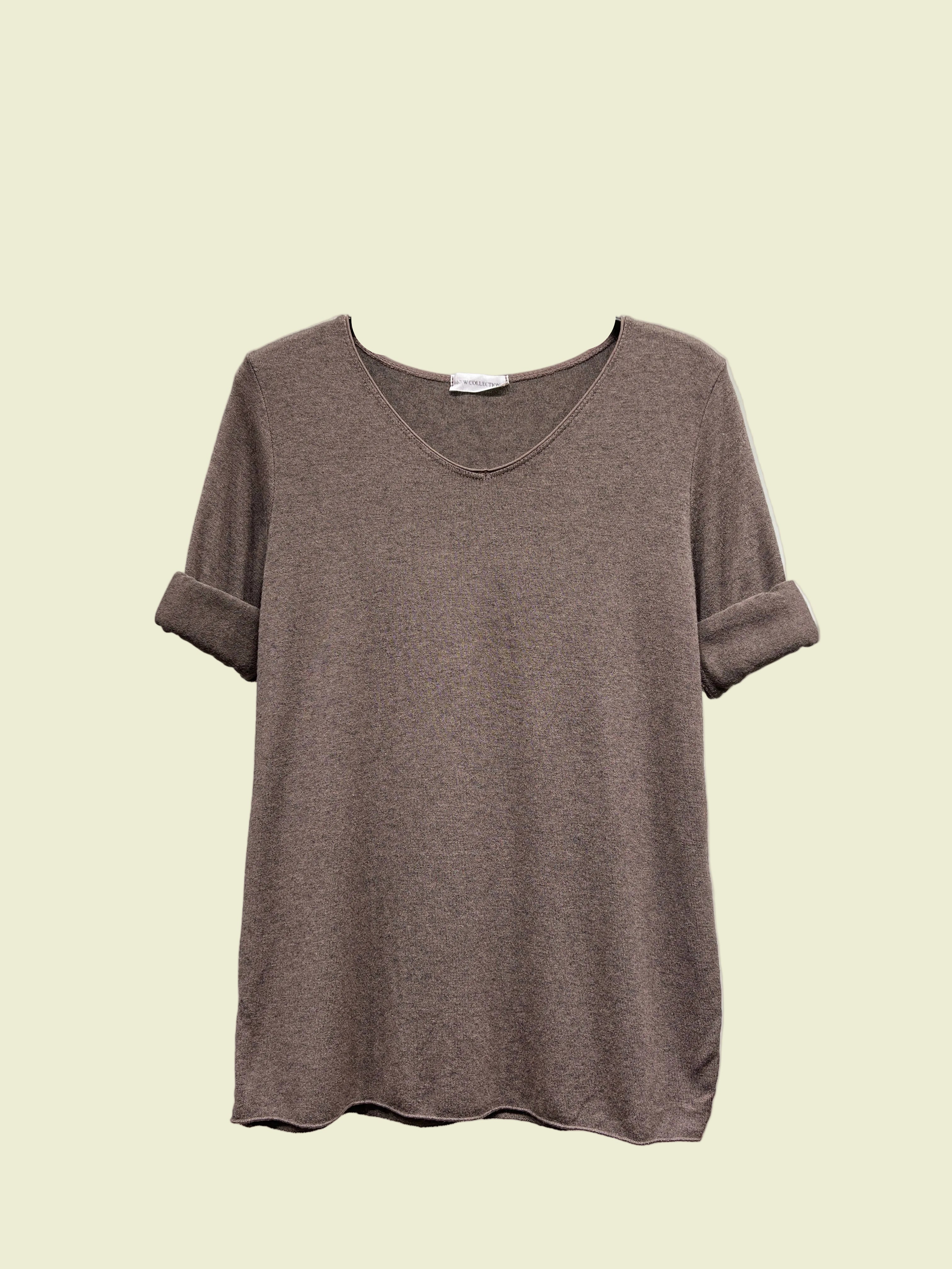 Brown t-shirt on a hanger against a neutral background