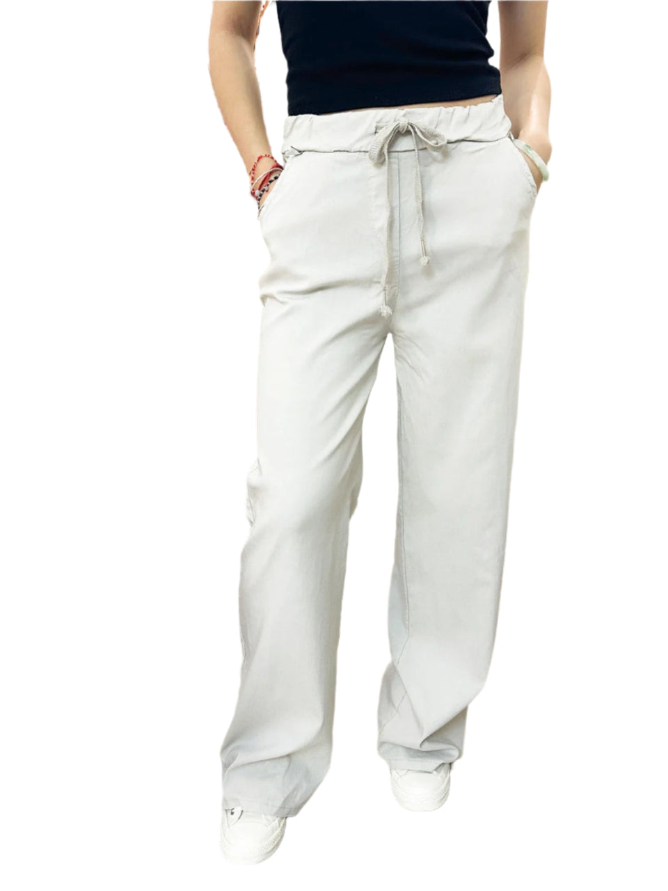 Person wearing beige pants with a white background.