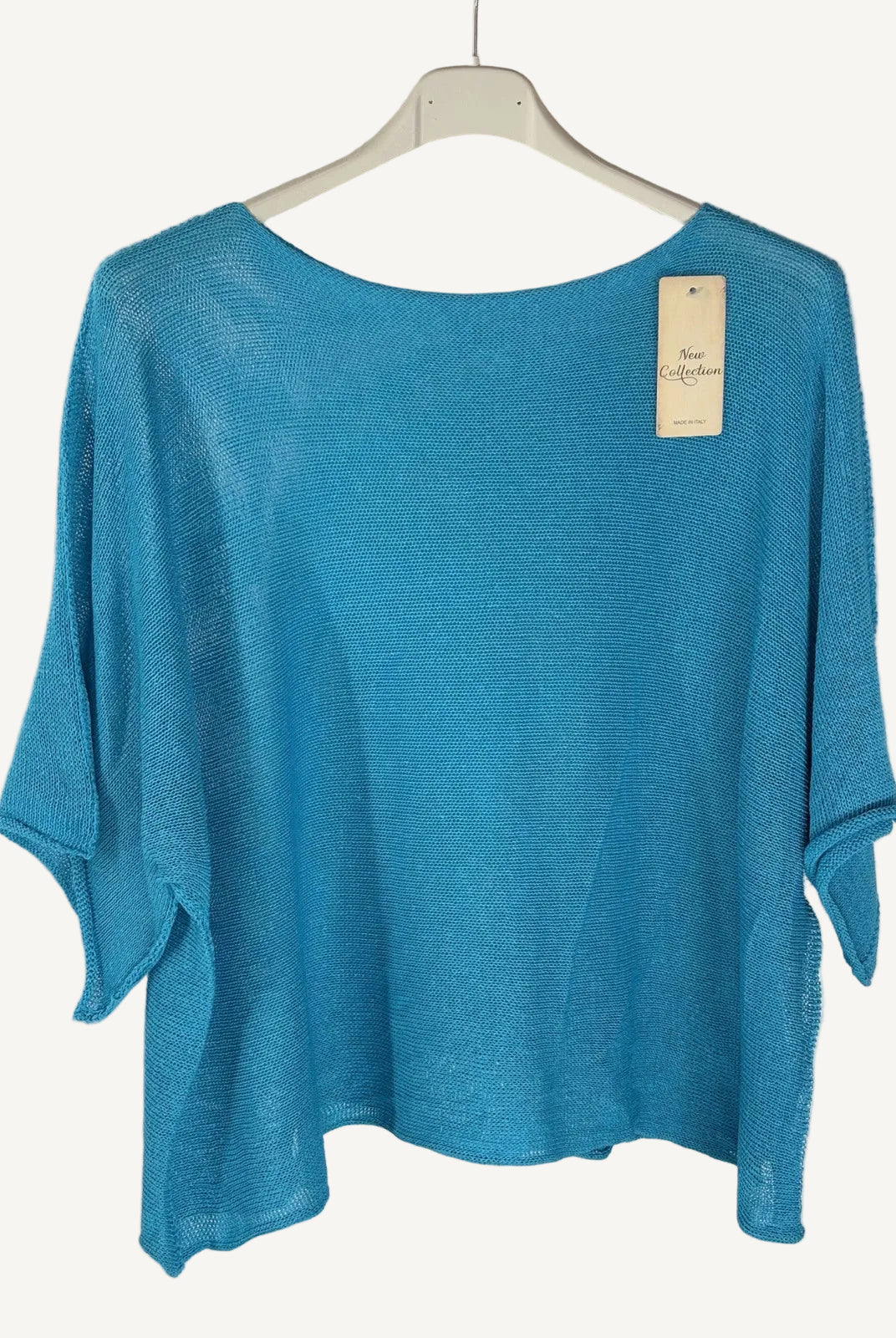Blue sweater on a hanger with a white background