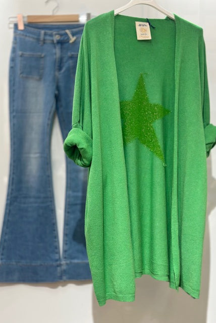 Green cardigan with a star design and blue jeans on a white background