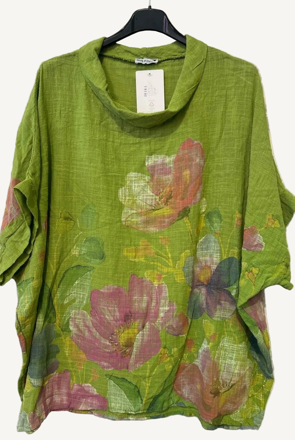 Green floral print top on a hanger against a white background