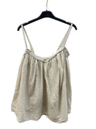 Beige sleeveless top on a hanger against a white background