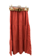 Red skirt with a belt on a hanger against a white background