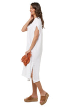 Woman wearing a white dress with brown sandals on a white background