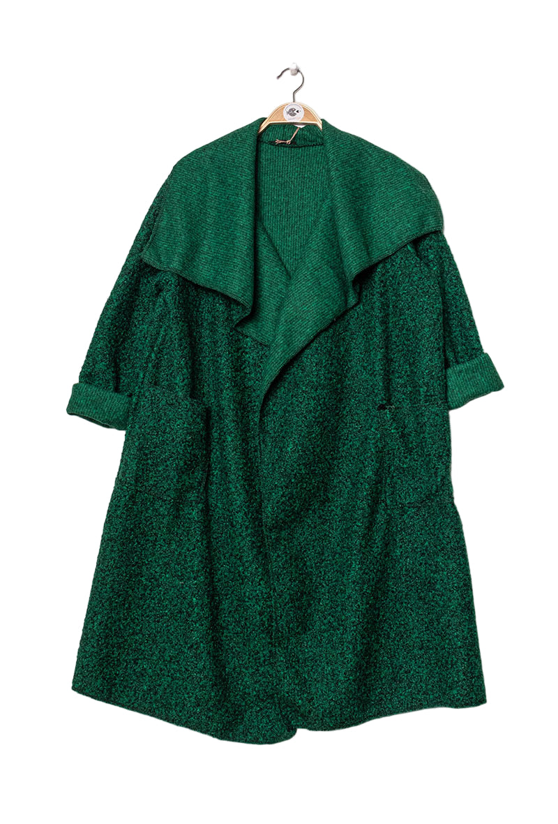 Green coat on a hanger against a white background
