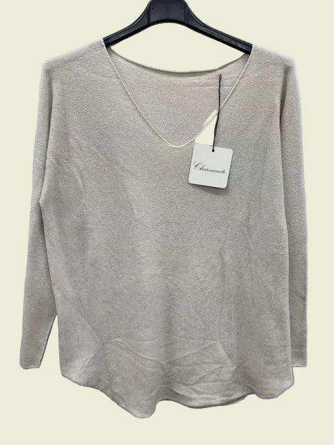 beige sweater on a hanger with a brand tag against a white background