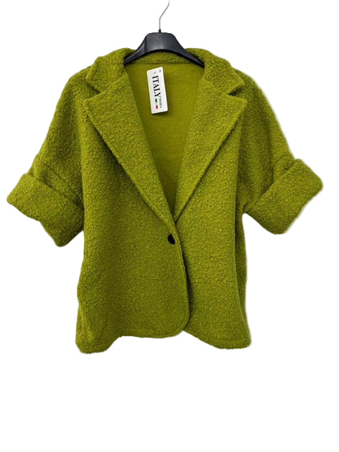 Green coat on a hanger against a white background