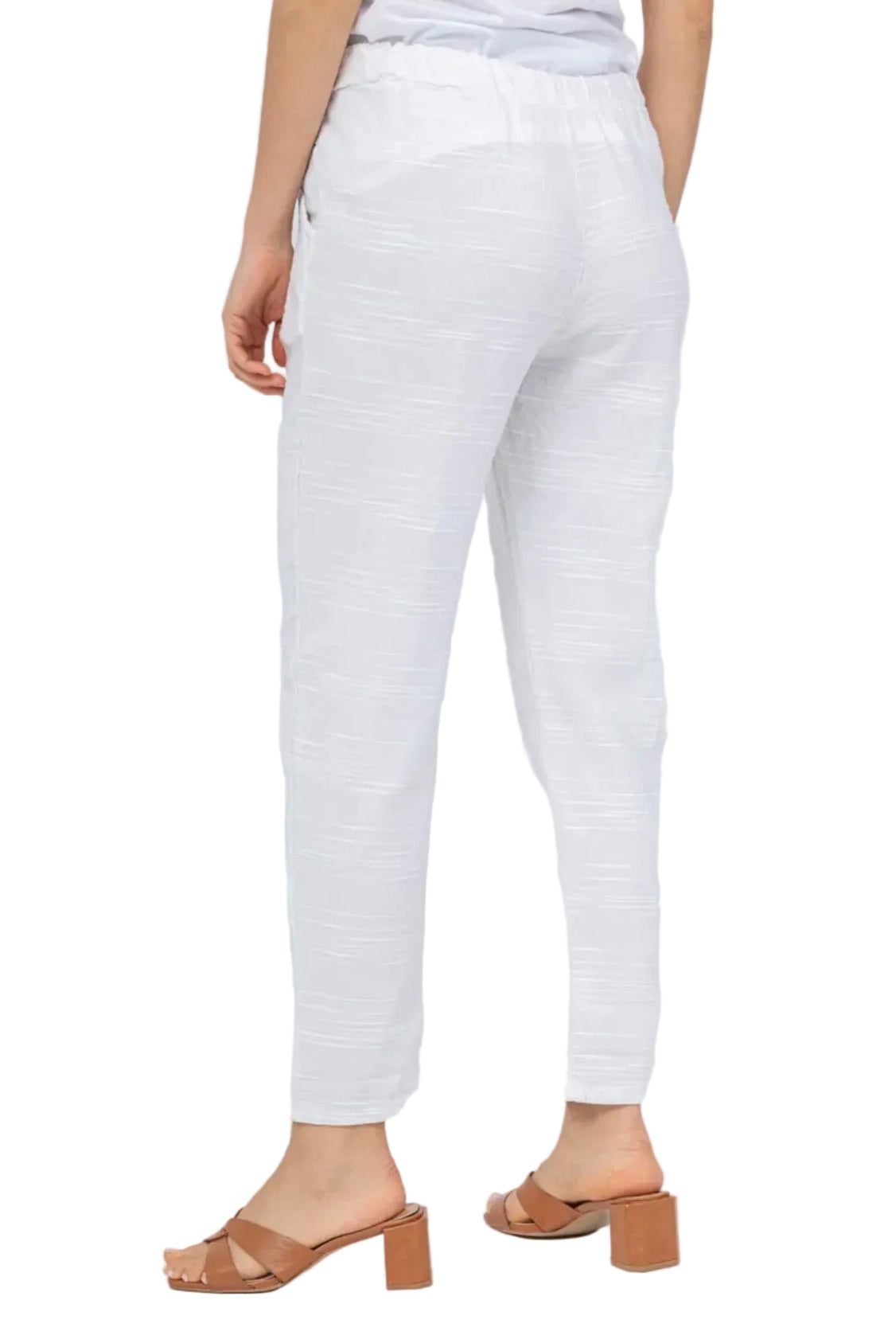 White pants worn by a person on a white background