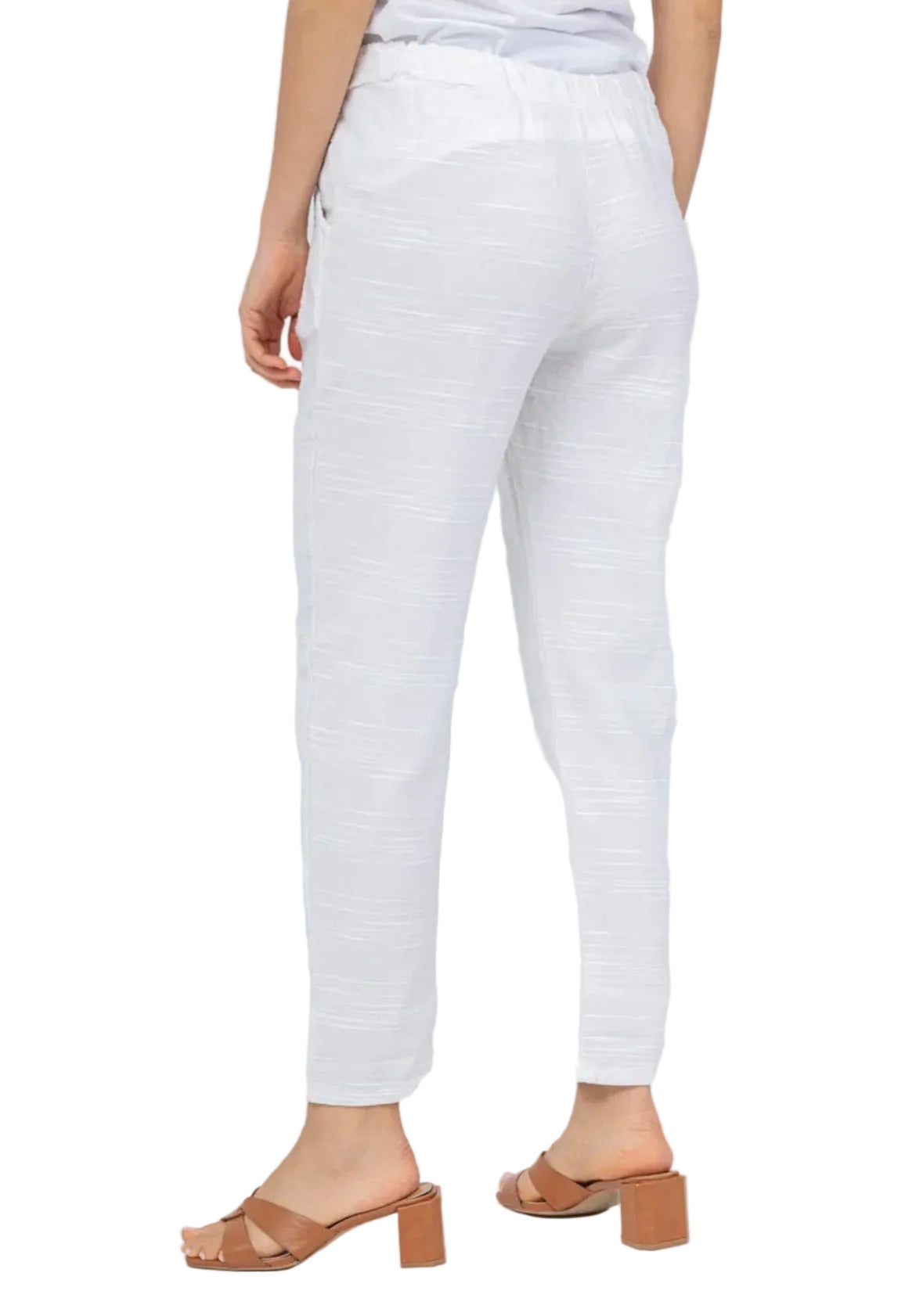 White pants worn by a person on a white background