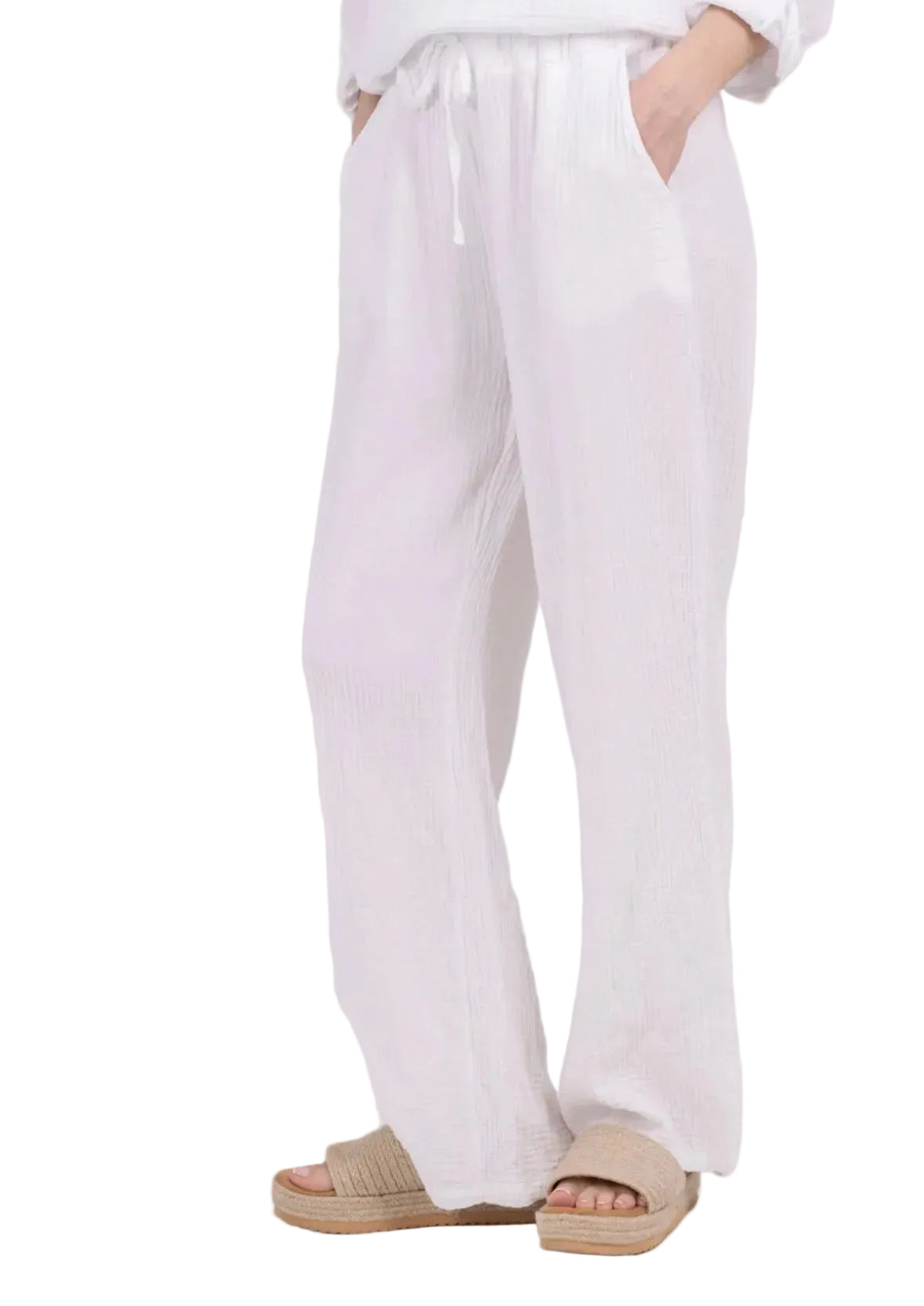 White pants worn by a person on a white background