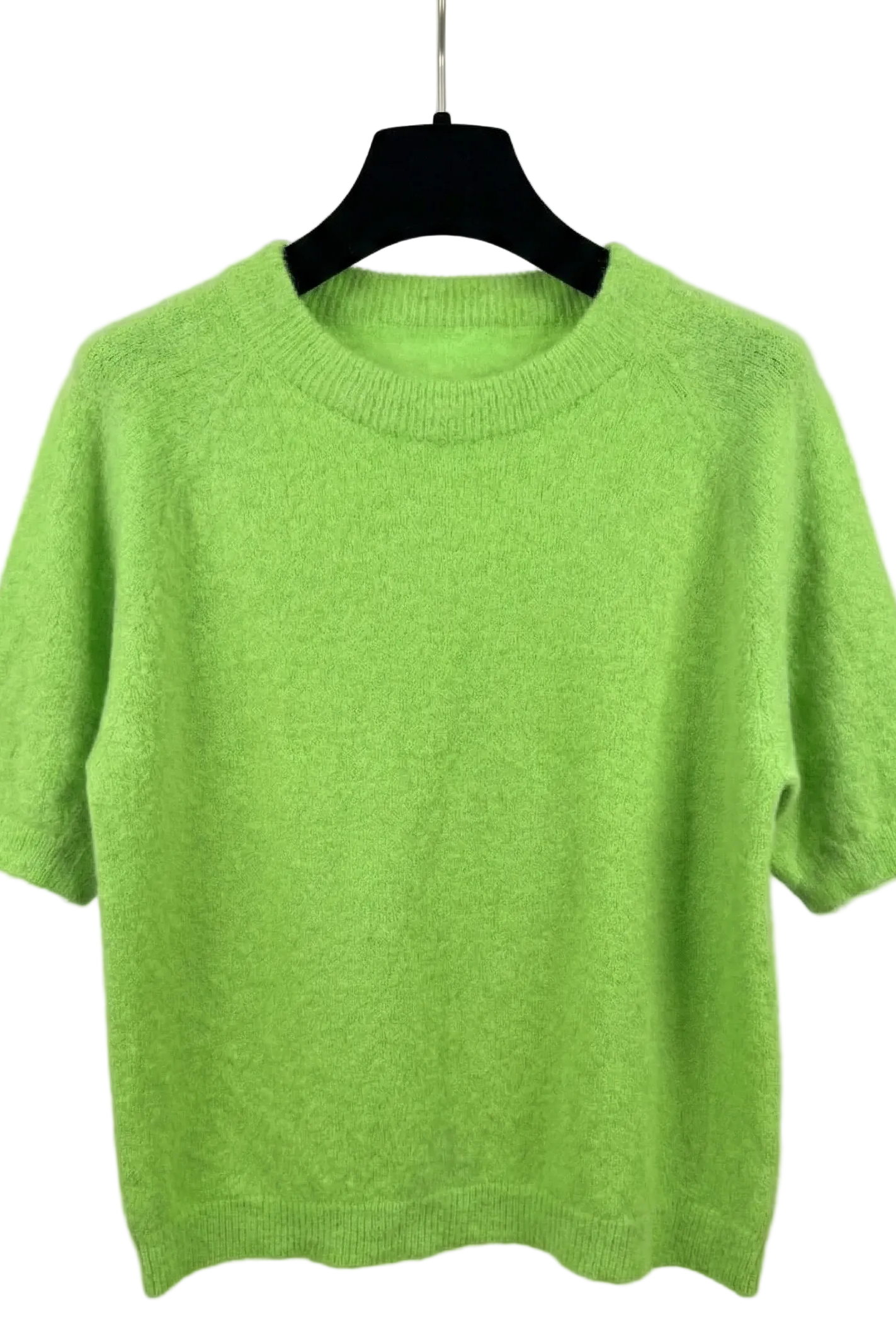 Green sweater on a hanger against a white background