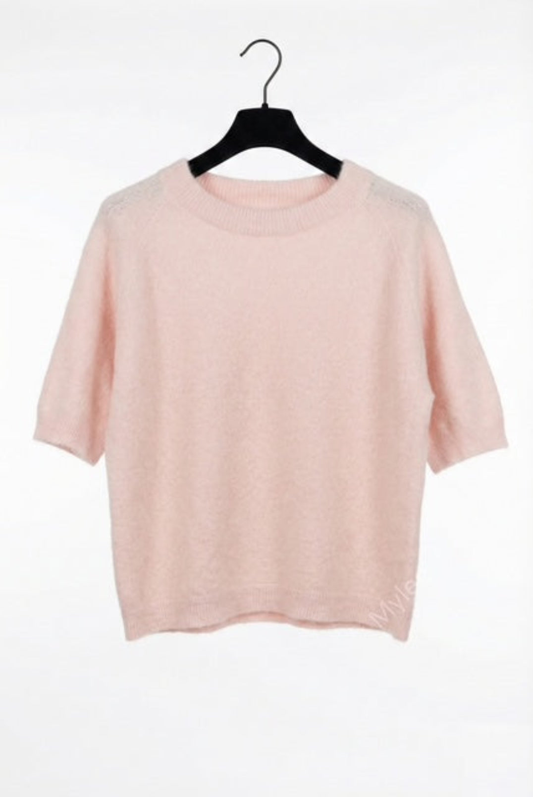 Pink t-shirt on a black hanger against a white background