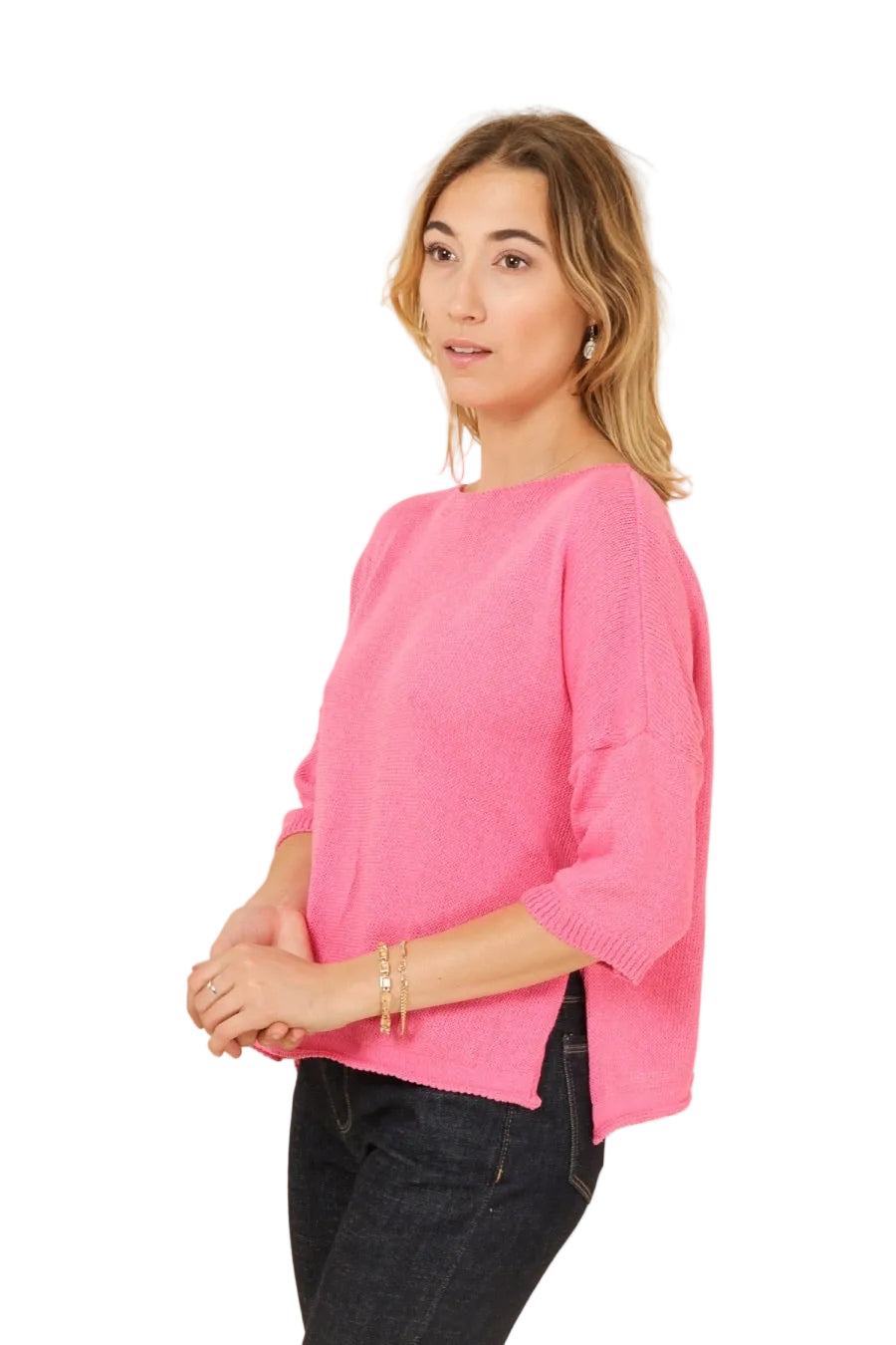 Woman wearing a bright pink sweater against a beige background