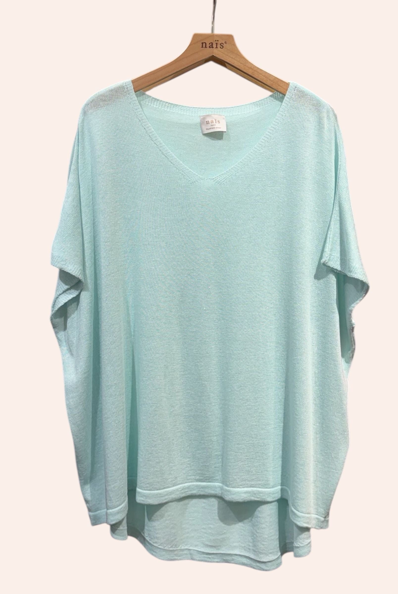 vert d'eau sweater on a hanger