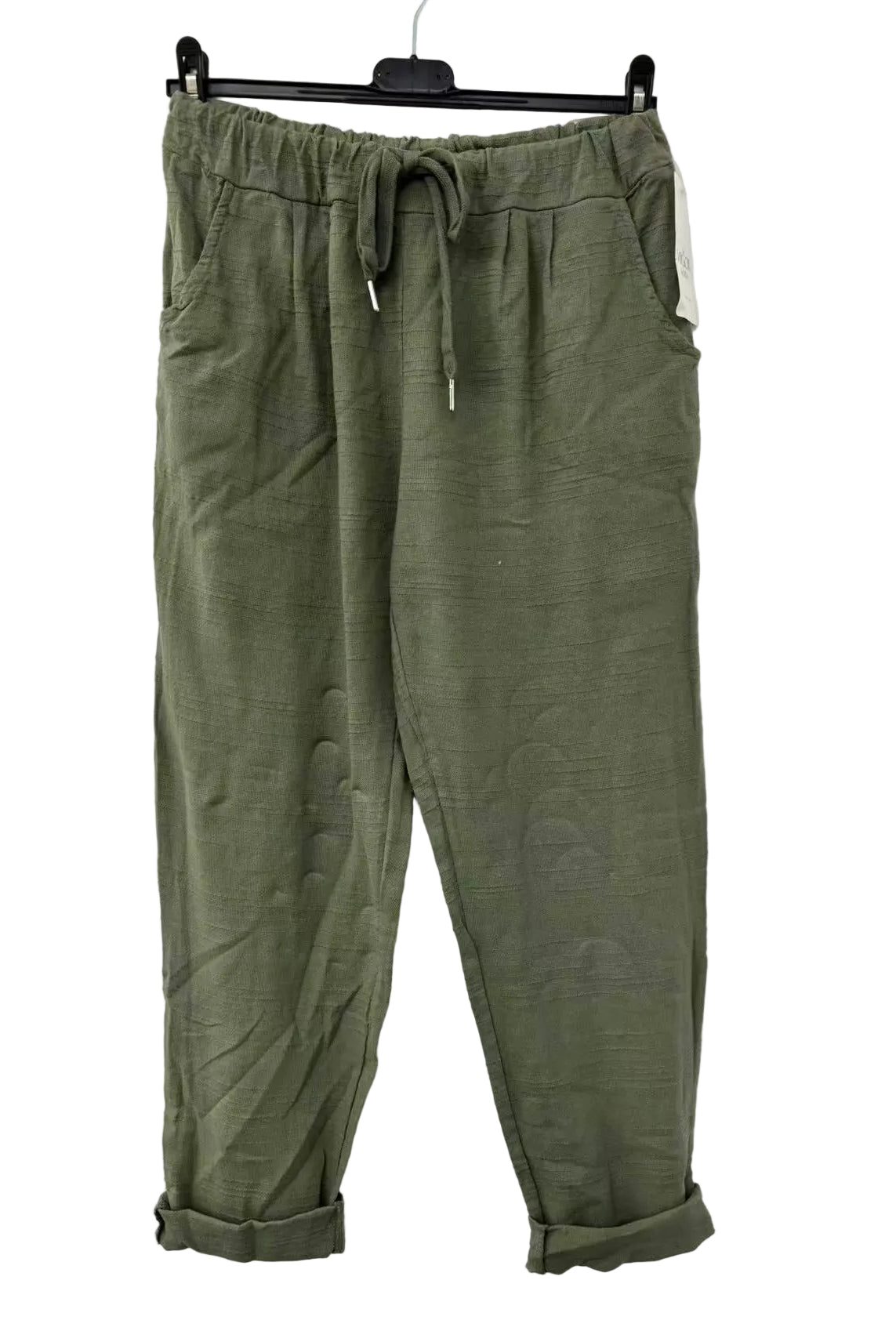 Green pants hanging on a white background
