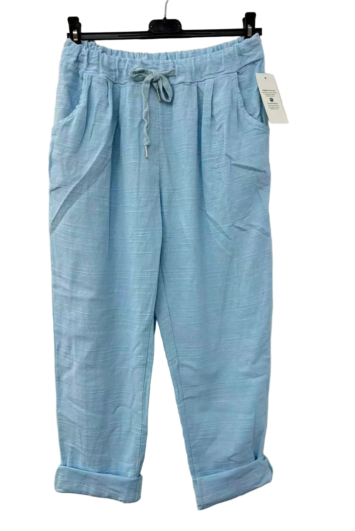 Light blue pants with a drawstring on a hanger against a white background