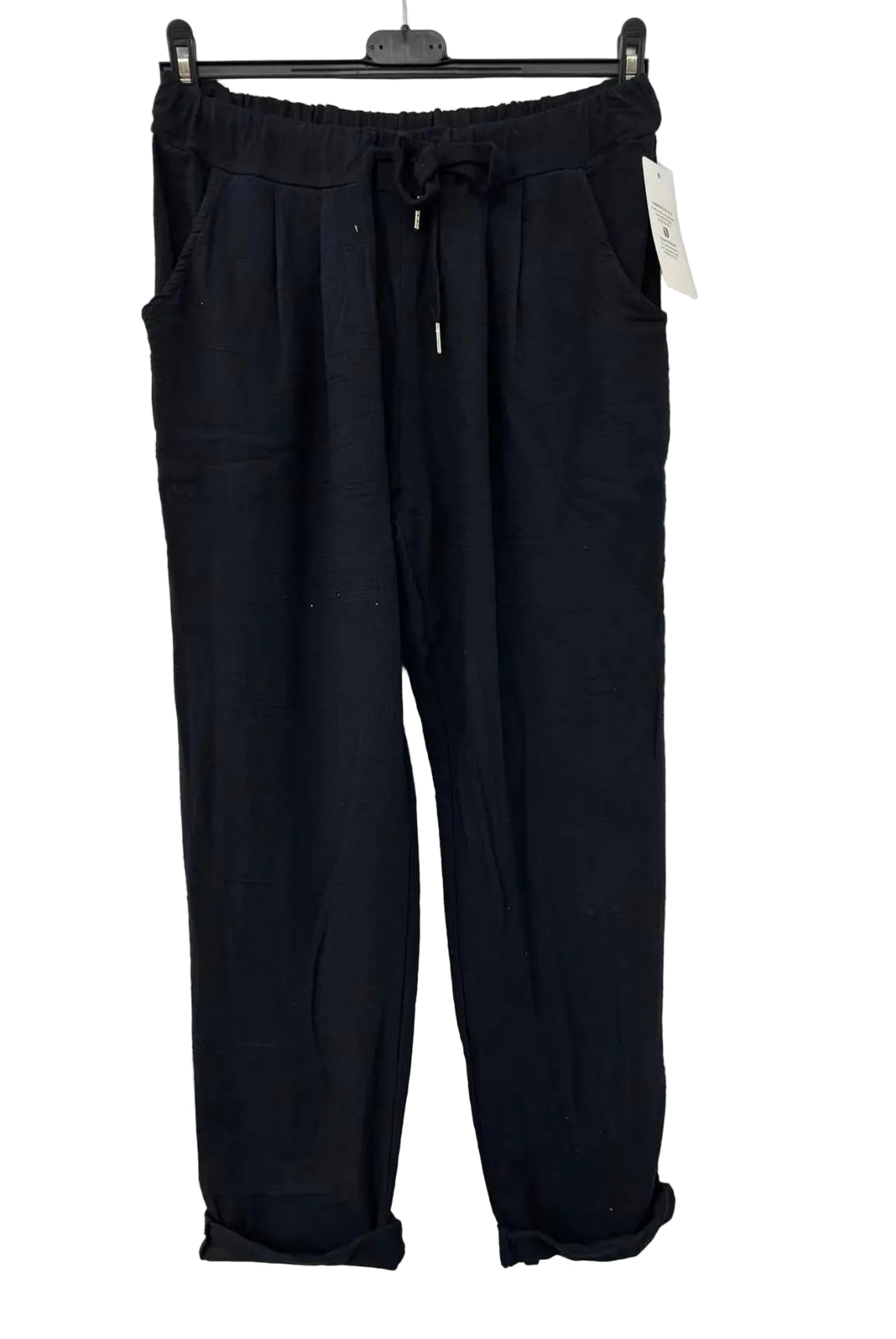 Black pants on a hanger against a white background