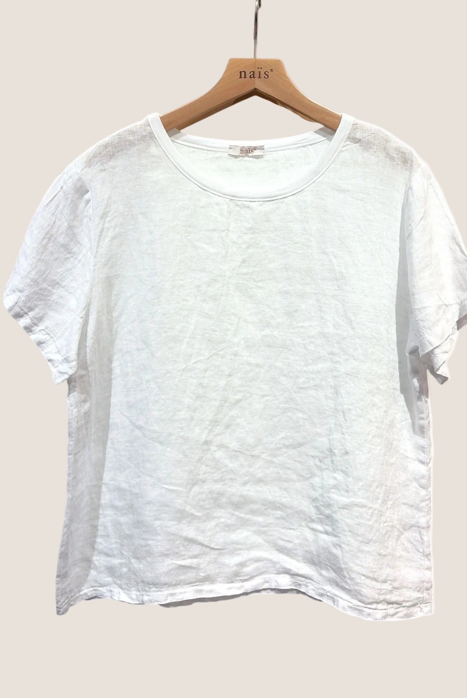 White linen t-shirt on a wooden hanger