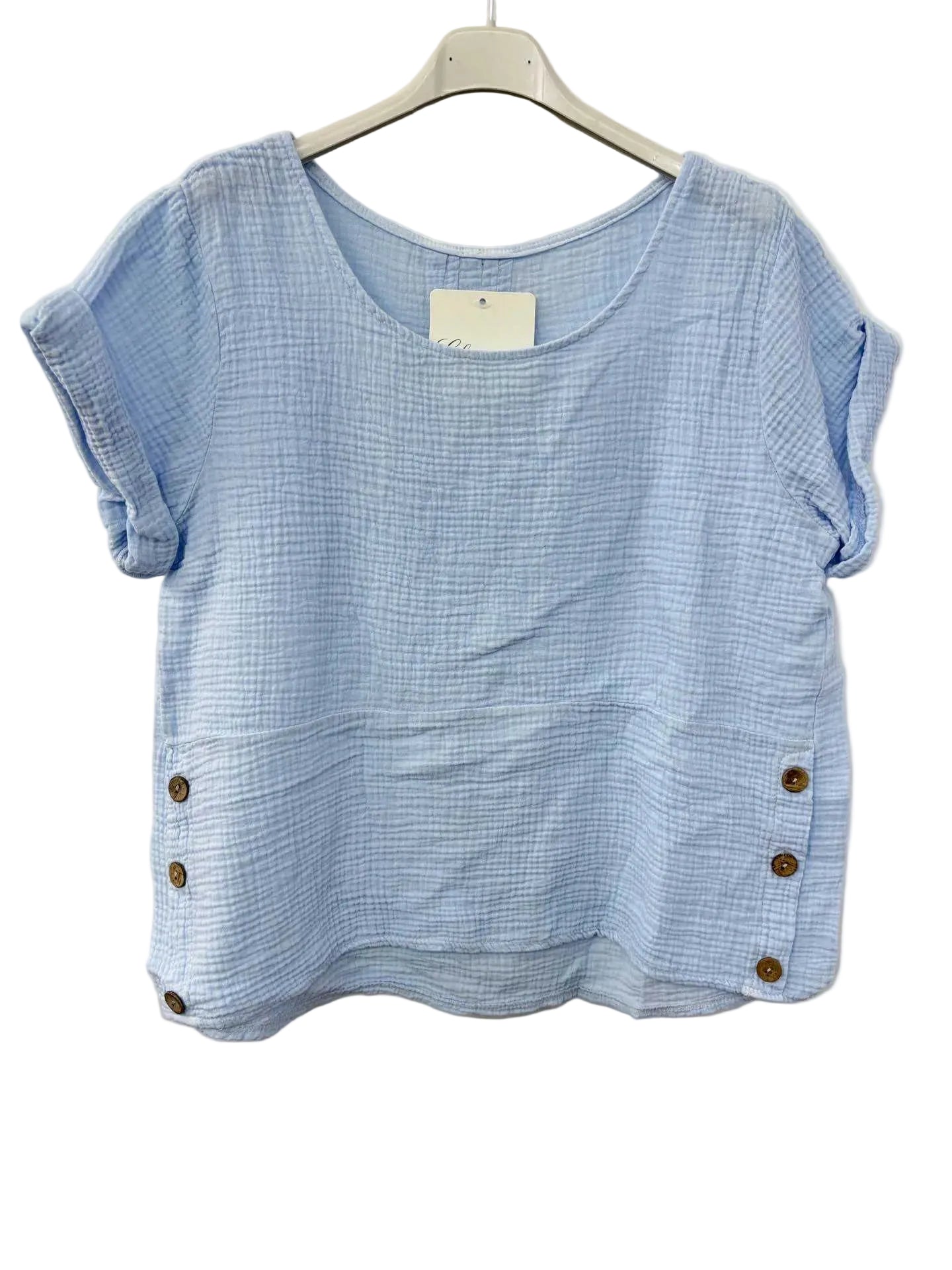 Blue cotton gauze top with button details on a white background