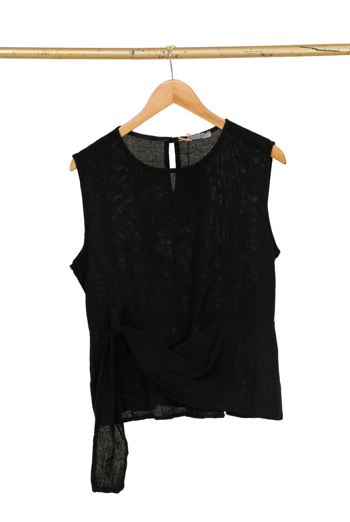 Black sleeveless top on a wooden hanger against a white background