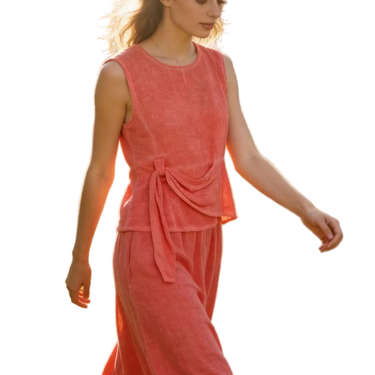 Woman in a coral linen top & skirt with white background