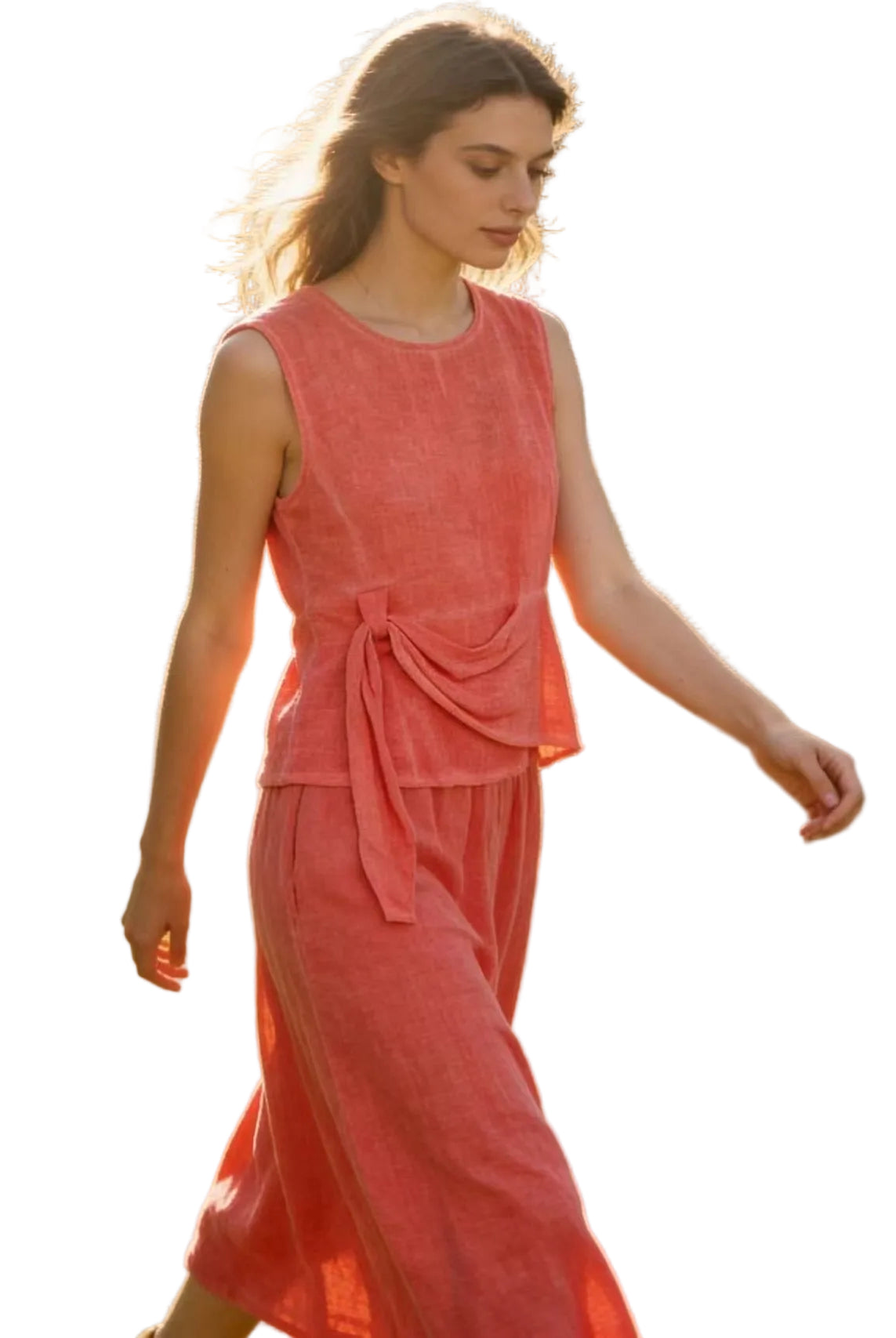 Woman in a coral linen top & skirt with white background