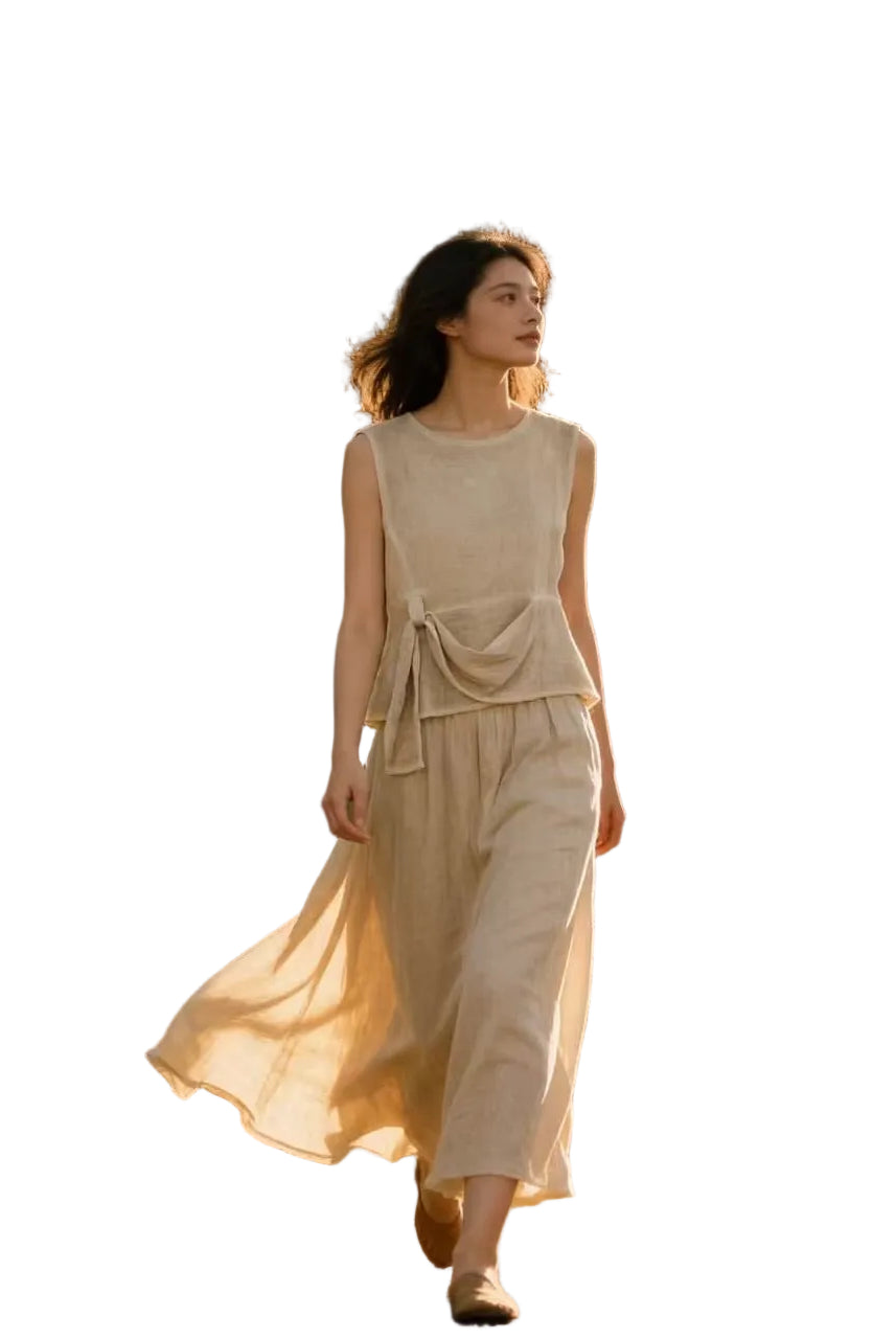 Woman in a beige top & skirt with a white background