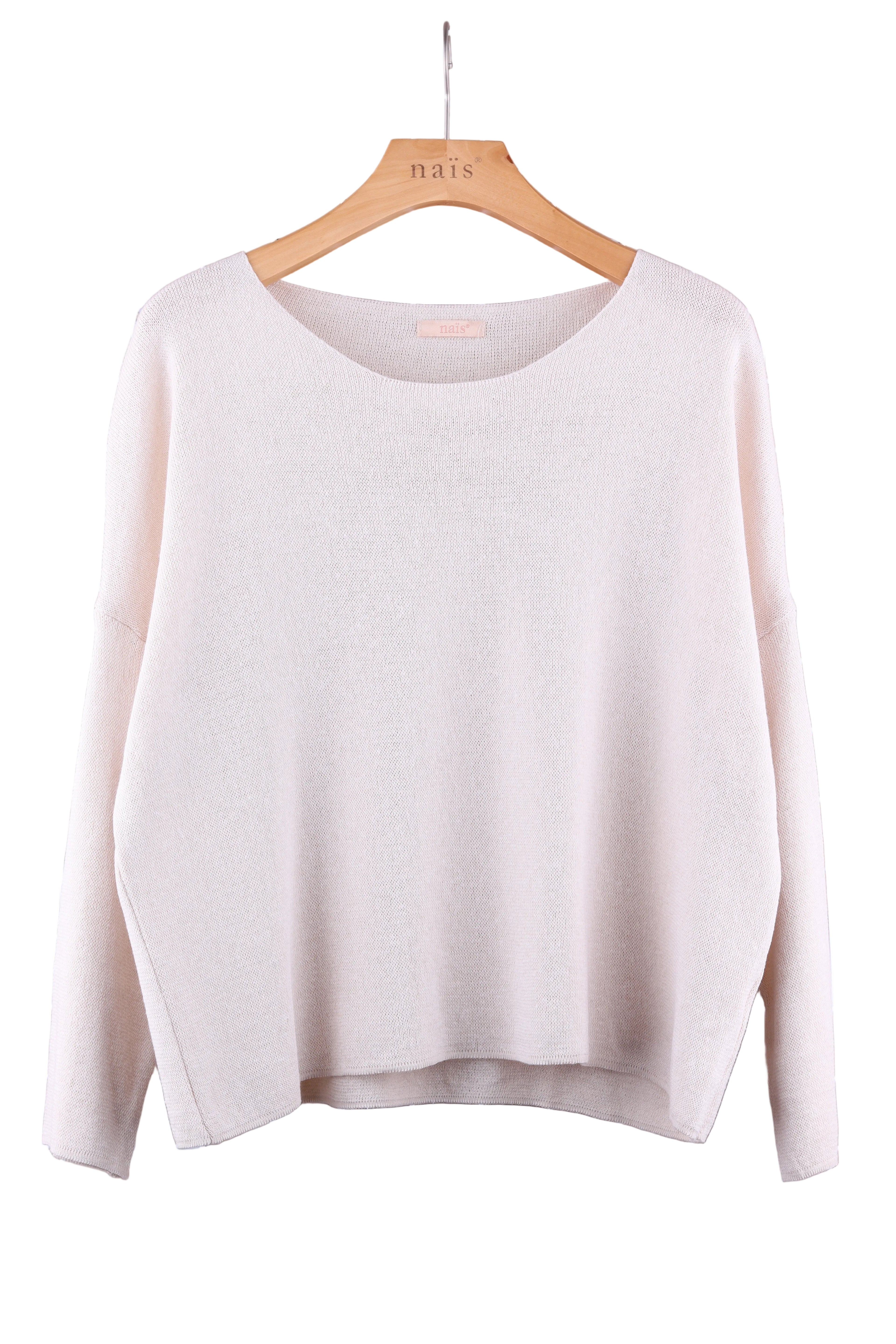 Light beige sweater on a hanger against a white background