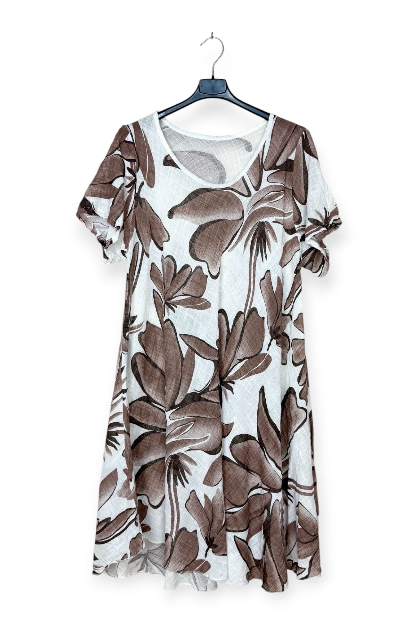 Floral patterned dress on a hanger against a white background