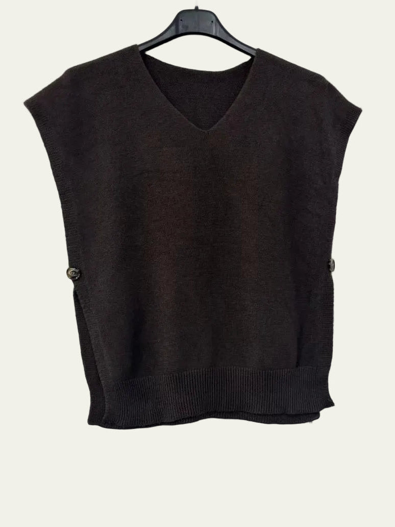 A dark brown sleeveless knit sweater vest with a V-neck and ribbed hem, hanging on a black hanger against a plain white wall.