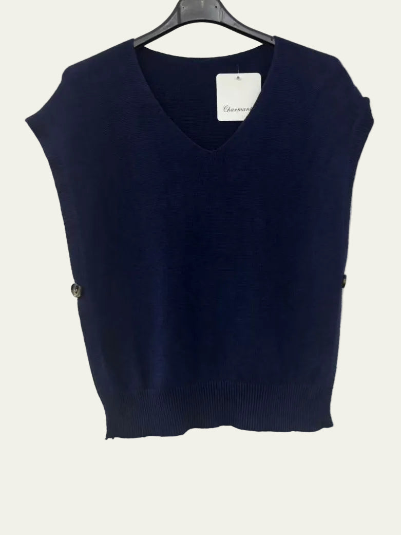 A navy blue sleeveless V-neck knit sweater vest hanging on a black hanger against a white wall.