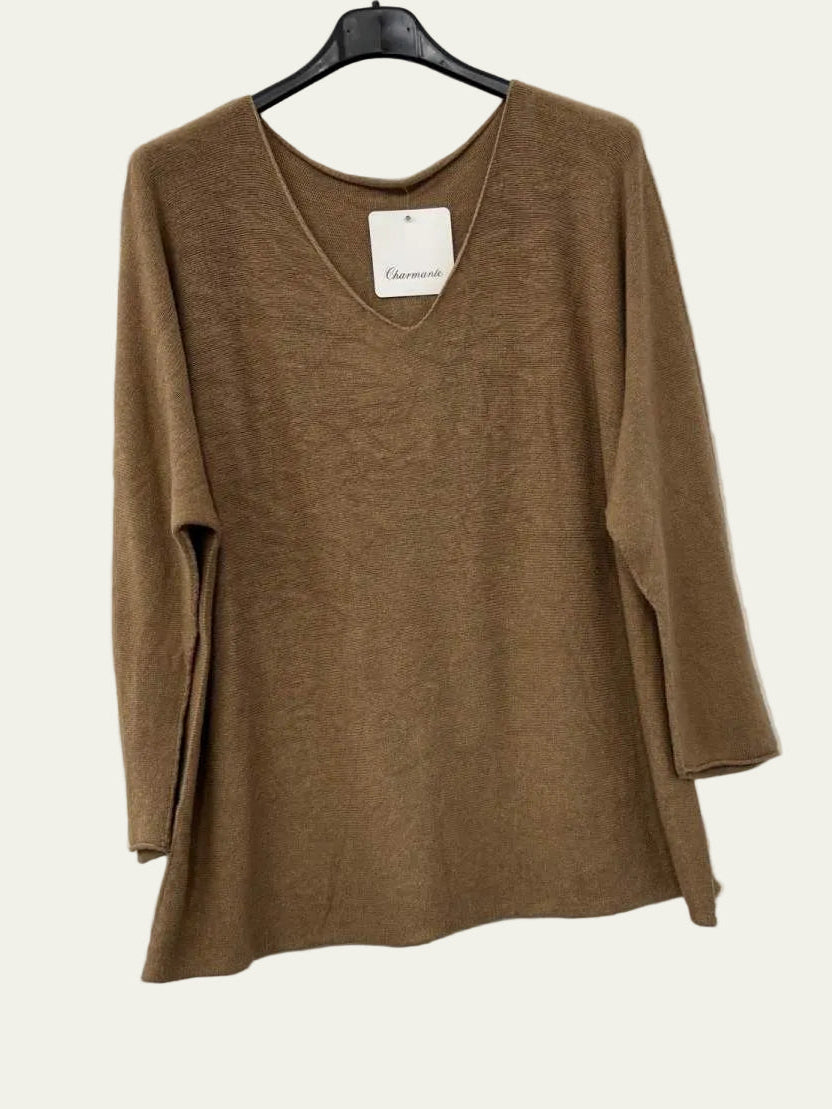 A brown long-sleeve knit top with a V-neck, hanging on a black hanger against a white wall.