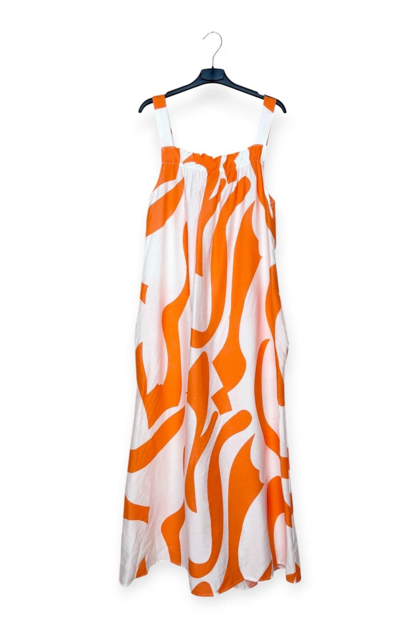 Orange and white patterned dress on a hanger against a white background