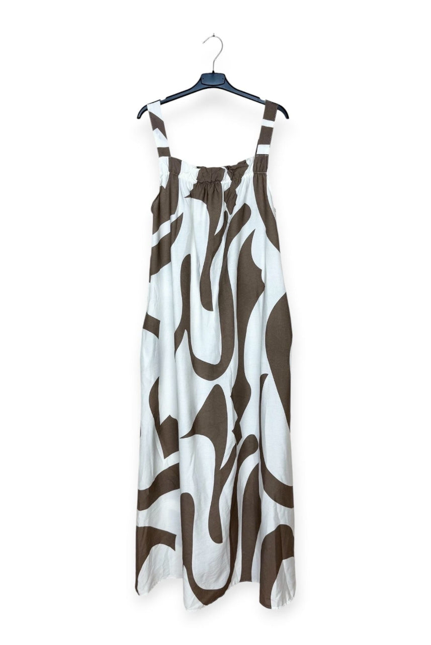 Taupe and white patterned dress on a hanger against a white background