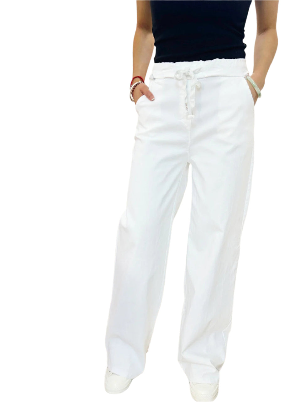 White pants worn by a person on a white background