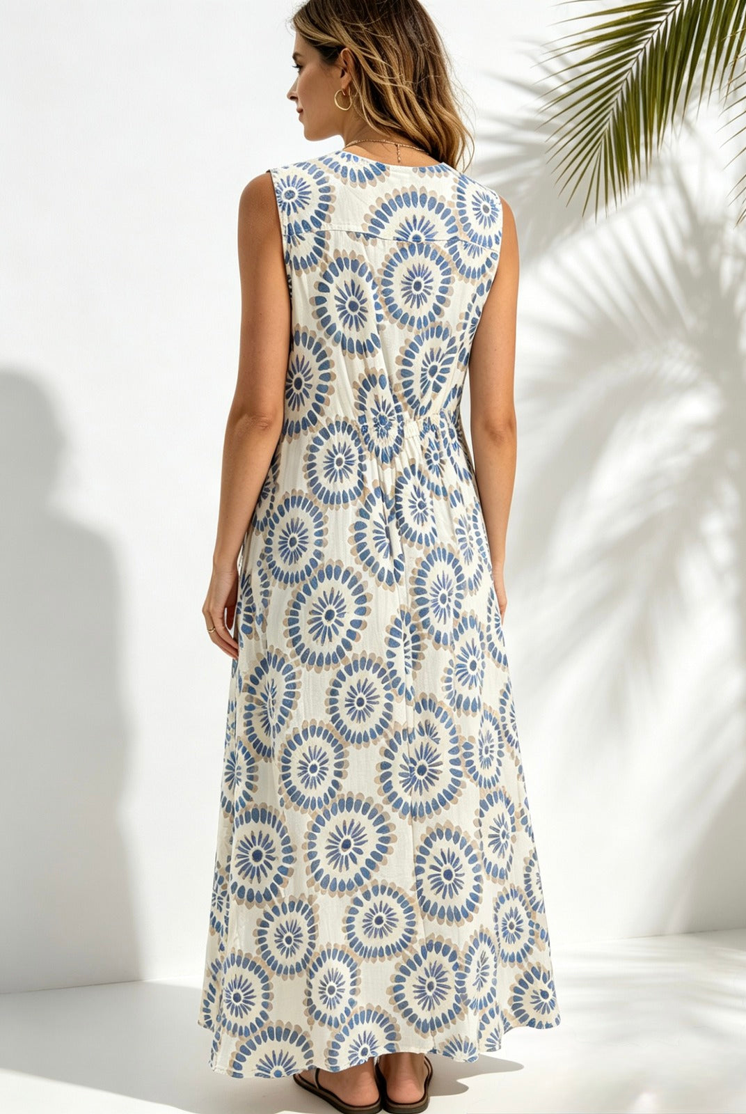 back view of lady wearing sky blue printed sleeveless dress