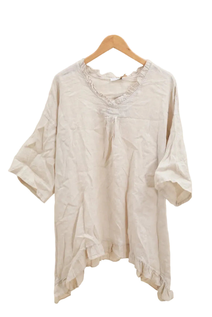 Beige blouse on a wooden hanger against a white background