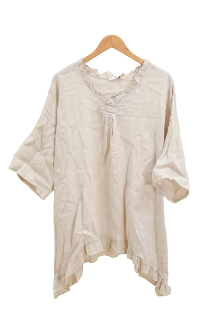 Beige blouse on a wooden hanger against a white background