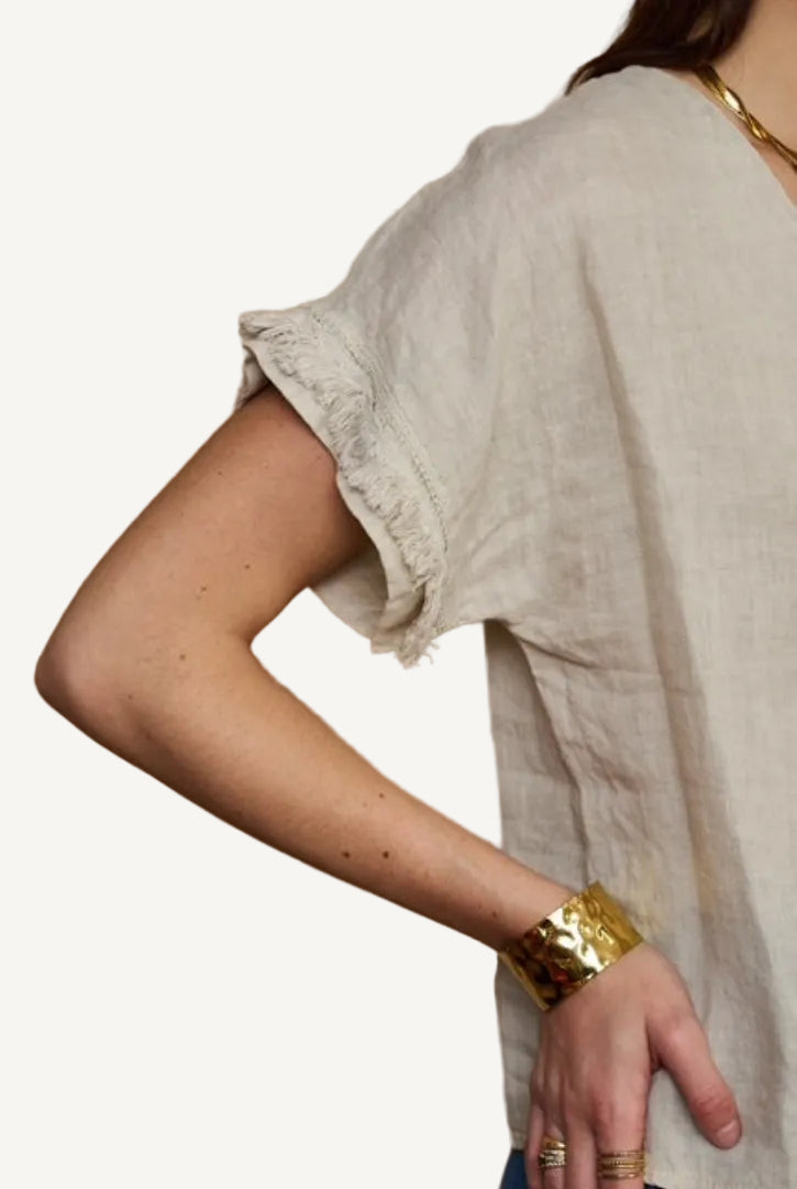 beige linen top with fringe detail to sleeve