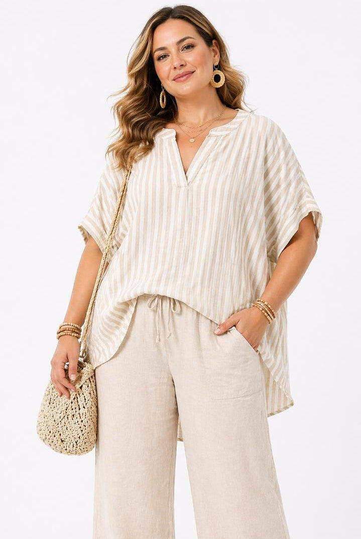 Woman wearing a beige outfit with a plain background