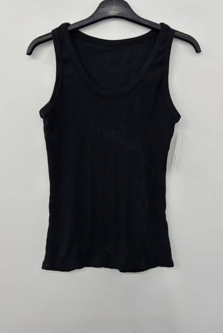 Black tank top on a hanger against a white background
