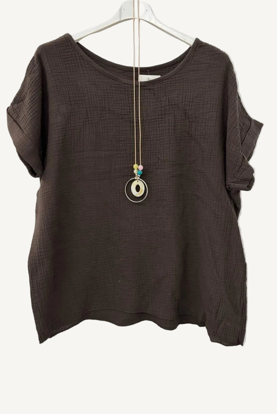 Brown textured top on a hanger with a necklace