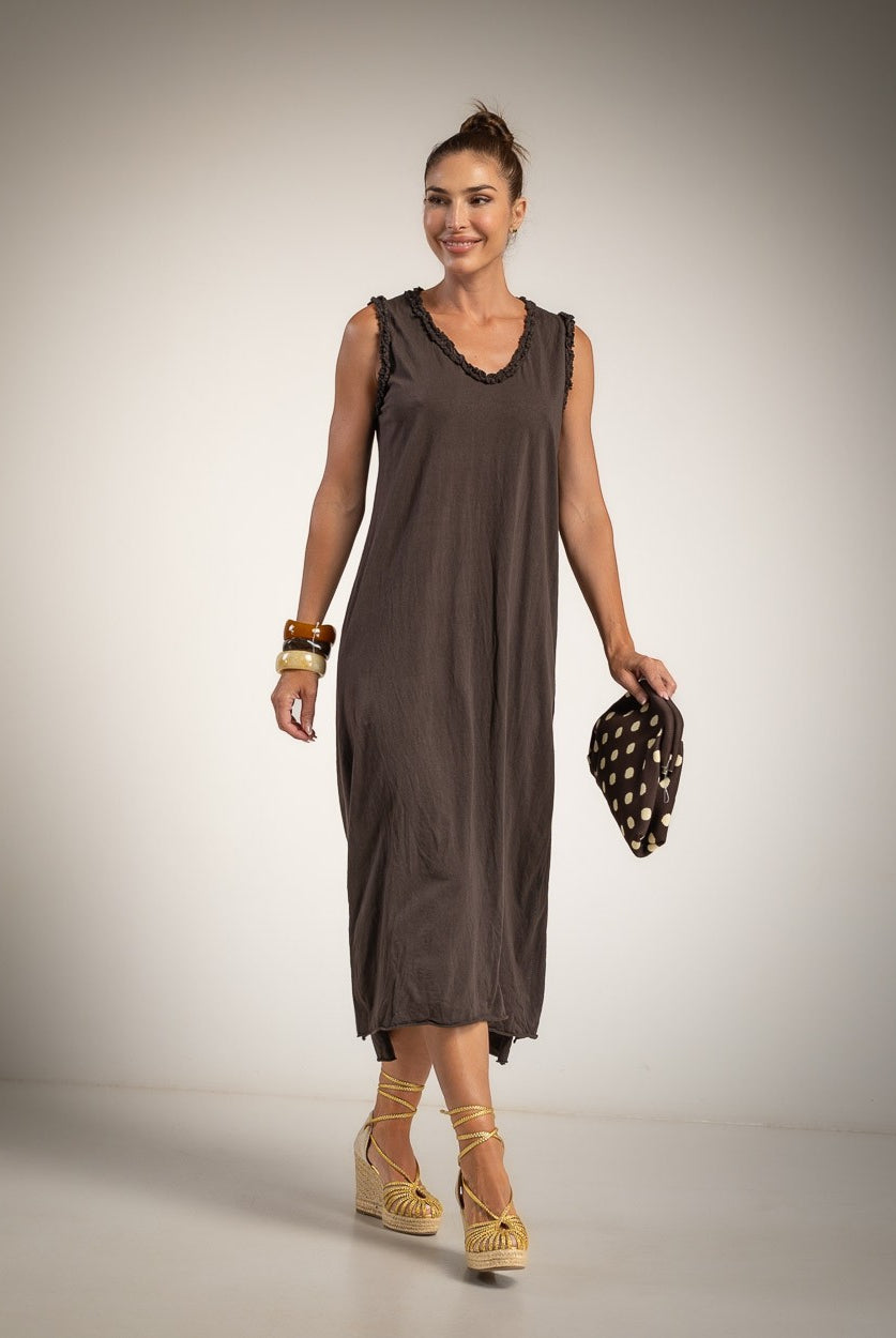 A woman modeling a sleeveless, dark brown midi dress with v neck