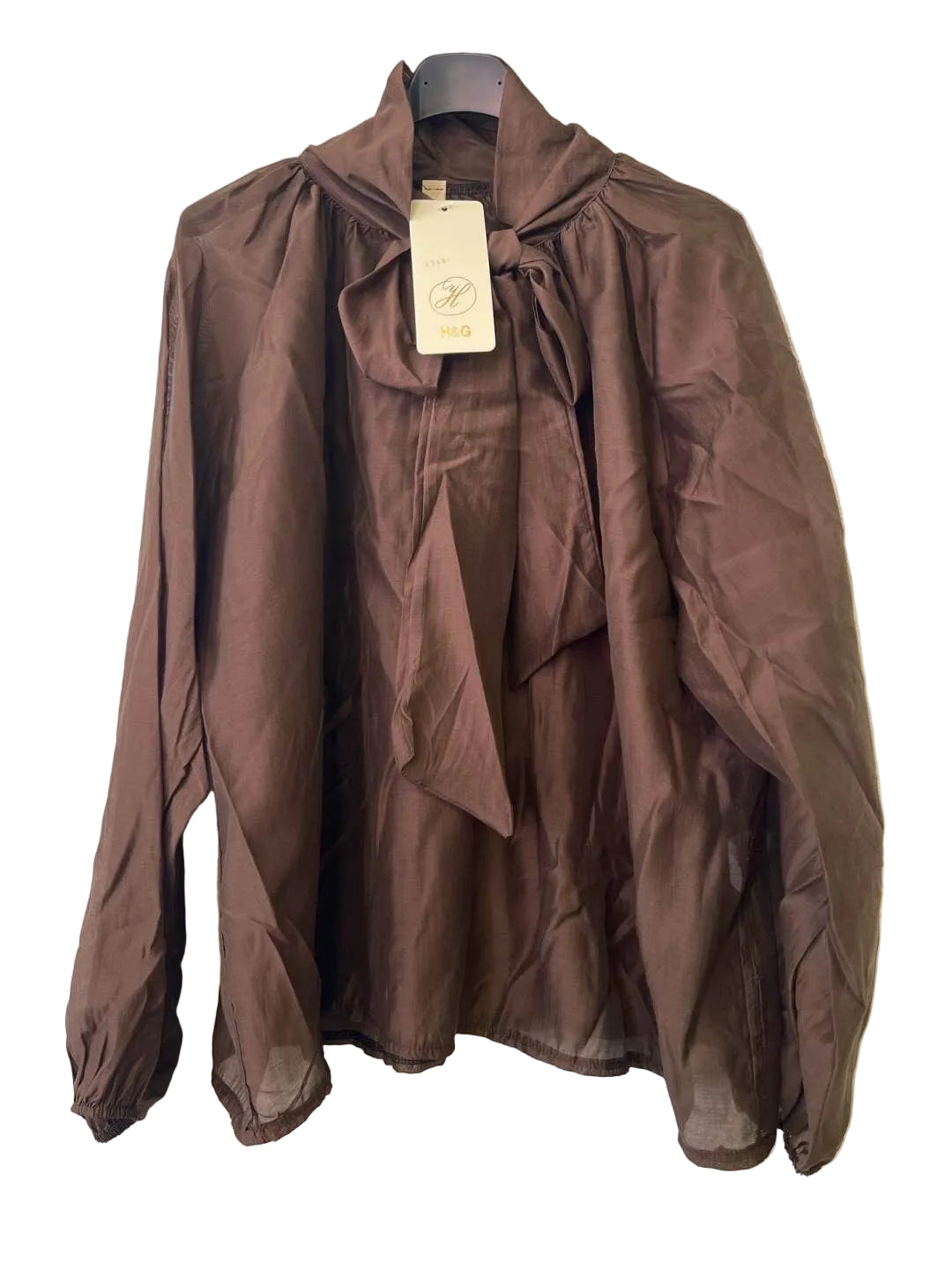 A brown long-sleeve blouse with a high gathered collar, front tie detail, and elasticized cuffs,