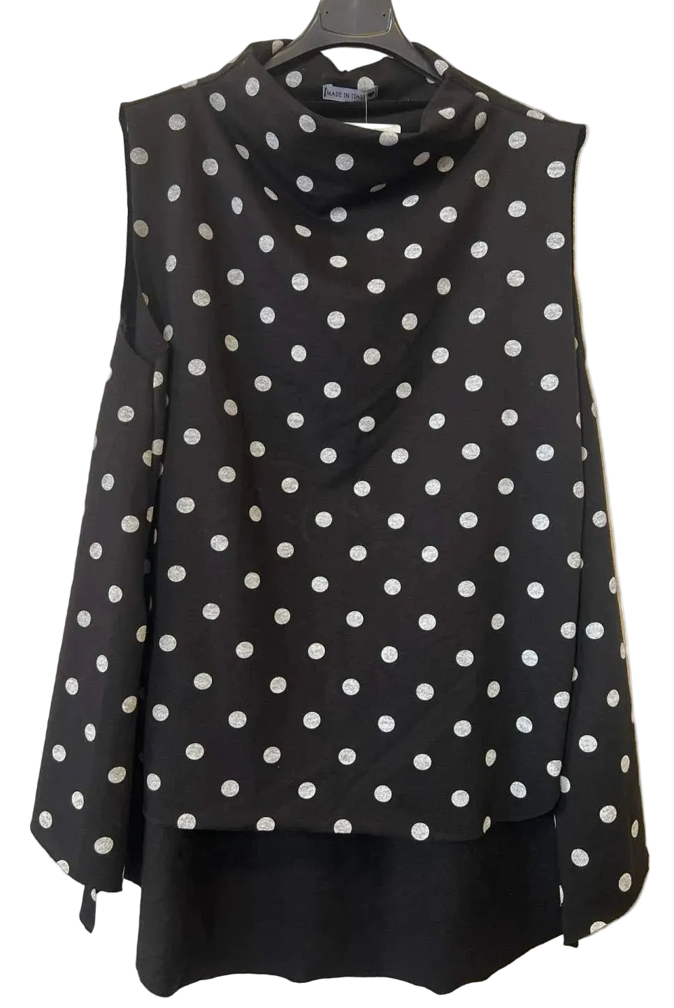 A sleeveless black cowl-neck top with white polka dots