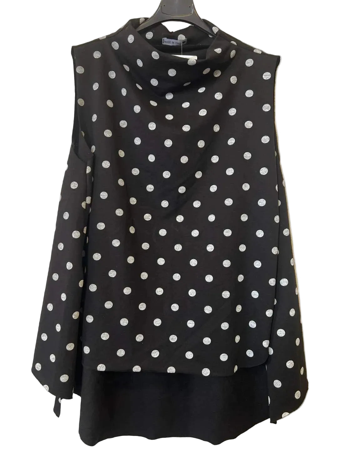A sleeveless black cowl-neck top with white polka dots