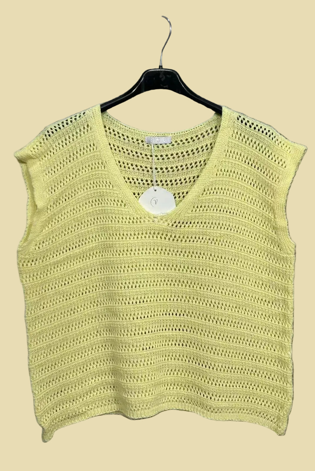 Yellow knitted top on a hanger