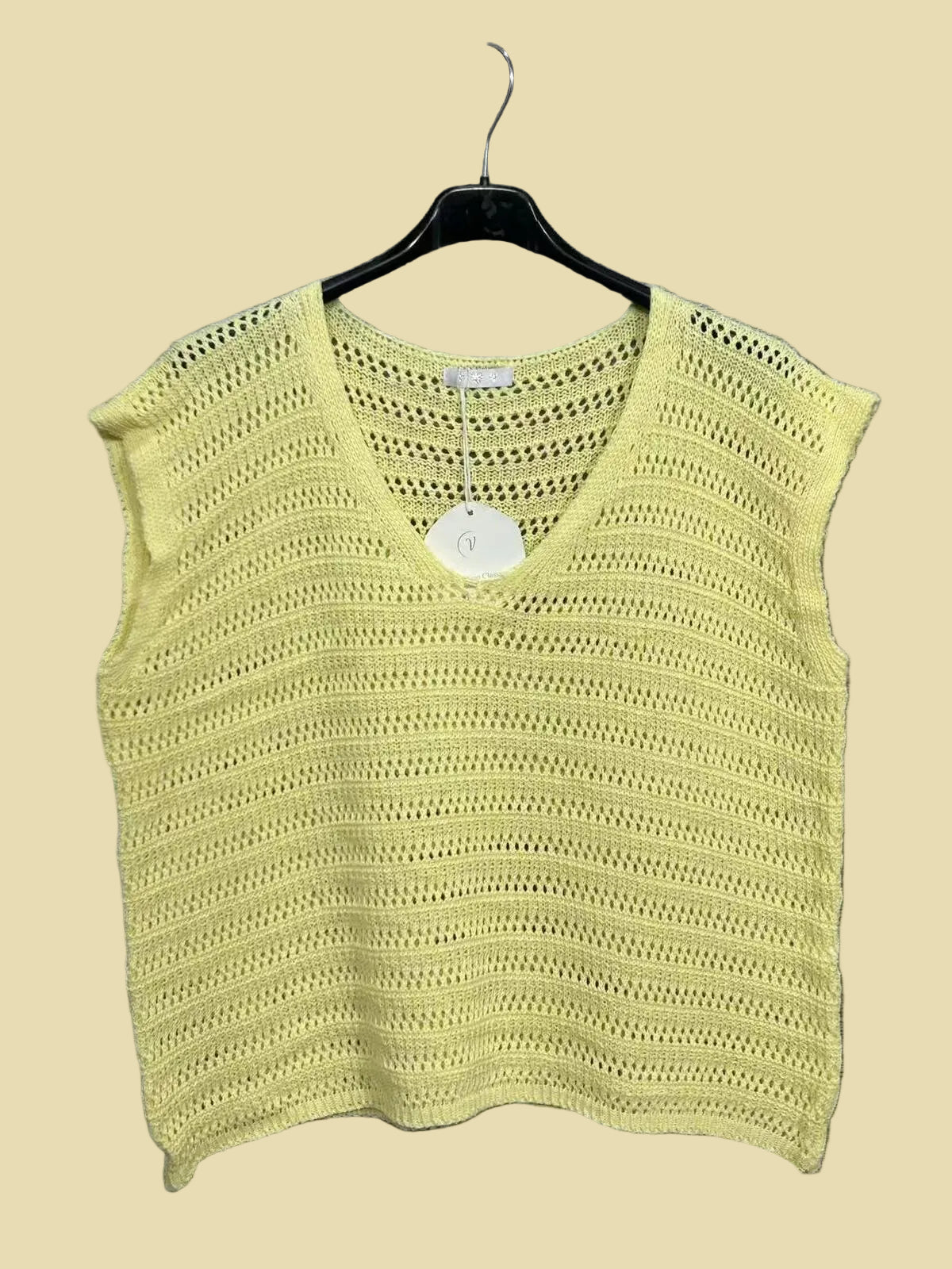 Yellow knitted top on a hanger