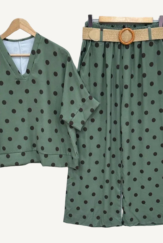 Green polka dot outfit with a belt on a white background