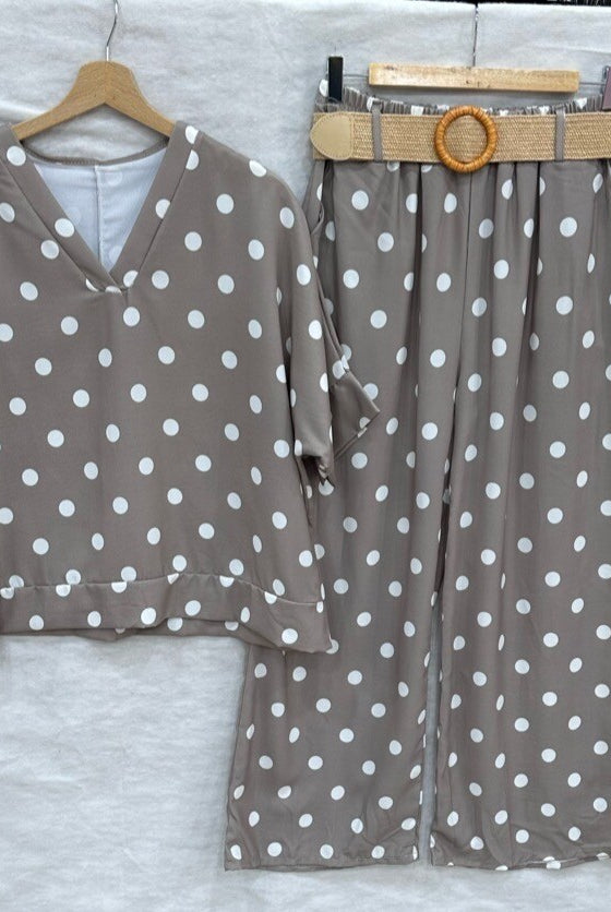 Taupe polka dot outfit with a belt on a white background